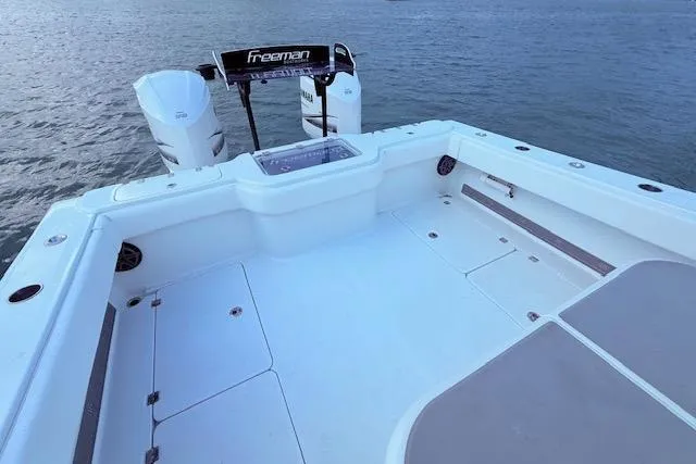 Slide: The Image of 2019 Freeman 34 boat deck with twin engines on calm water. - 57