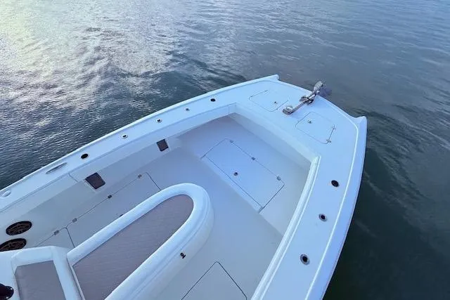 Slide: The Image of 2019 Freeman 34 boat deck on calm water, showcasing spacious seating and storage. - 58