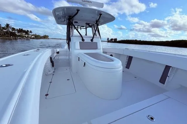 Slide: The Image of 2019 Freeman 34 boat with spacious deck, sleek design, and clear blue sky backdrop. - 60