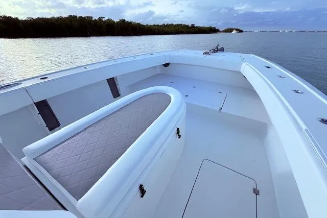 Slide: The Image of 2019 Freeman 34 boat interior with cushioned seating, on calm water. - 61