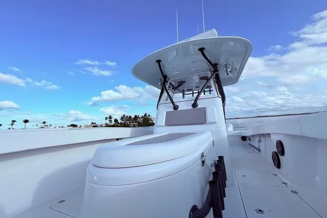 Slide: The Image of 2019 Freeman 34 boat with sleek design, open deck, and clear blue sky background. - 64