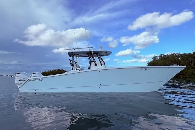 Slide: The Image of 2019 Freeman 34 boat on calm water under a partly cloudy sky. - 8