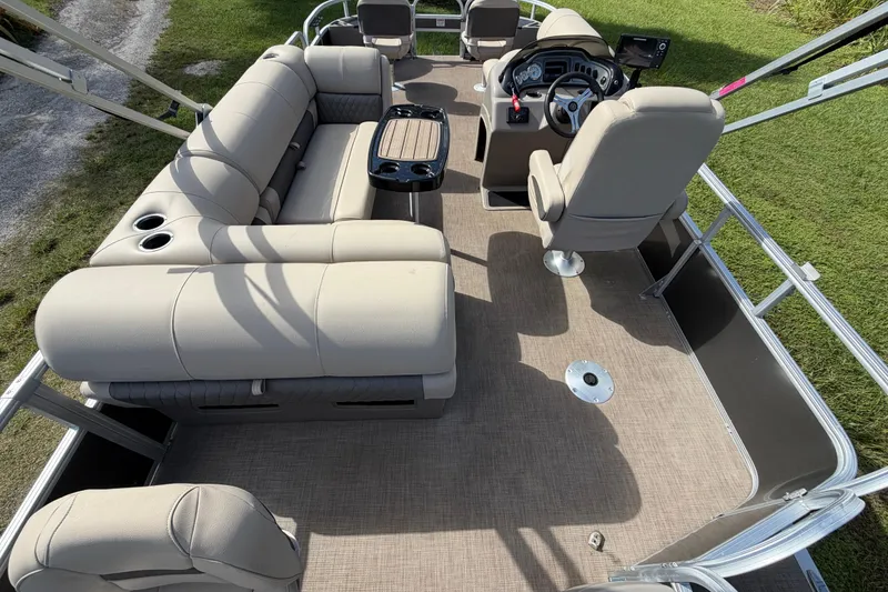 Slide: The Image of 2023 Sun Tracker Fishin' Barge 20 DLX interior with beige seating and steering console. - 37