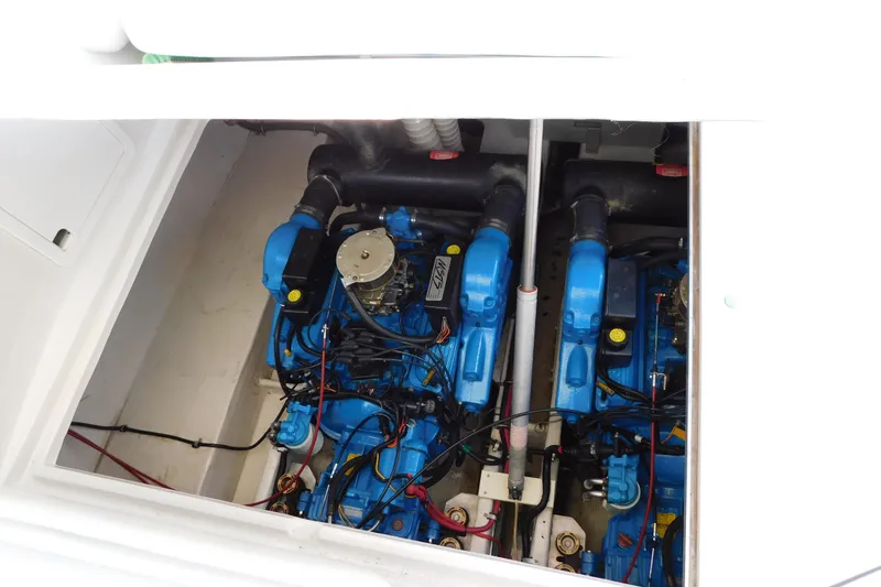Slide: The Image of Engine compartment of a 1996 Chris-Craft 340 Crowne boat, featuring dual blue engines. - 12
