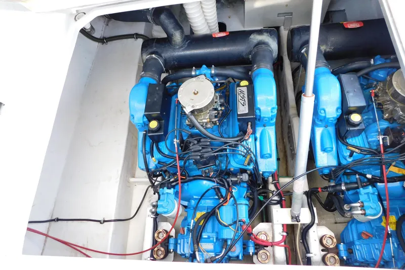 Slide: The Image of Engine compartment of a 1996 Chris-Craft 340 Crowne boat, featuring dual blue engines. - 13