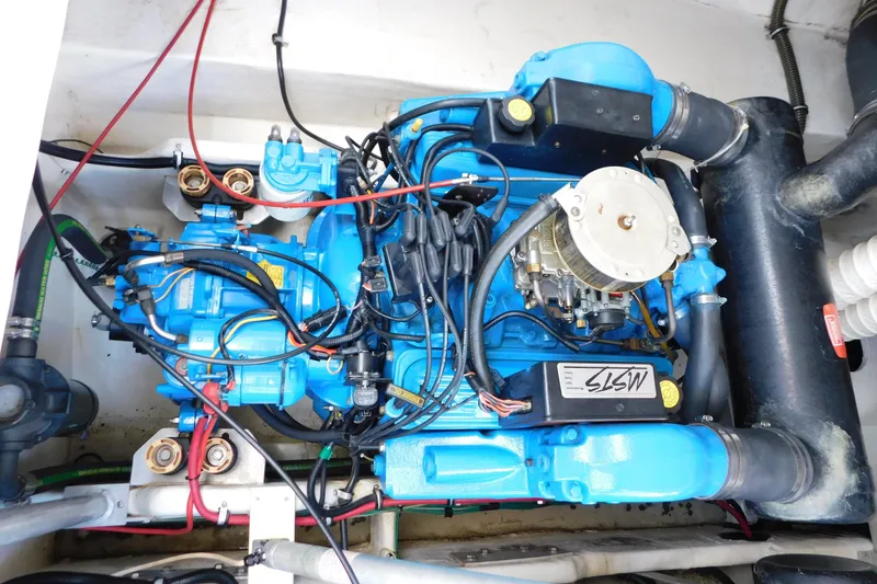 Slide: The Image of Engine compartment of a 1996 Chris-Craft 340 Crowne boat, featuring a blue engine. - 14