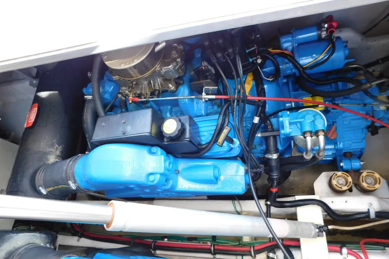 Slide: The Image of Engine compartment of a 1996 Chris-Craft 340 Crowne boat, featuring a blue marine engine. - 15