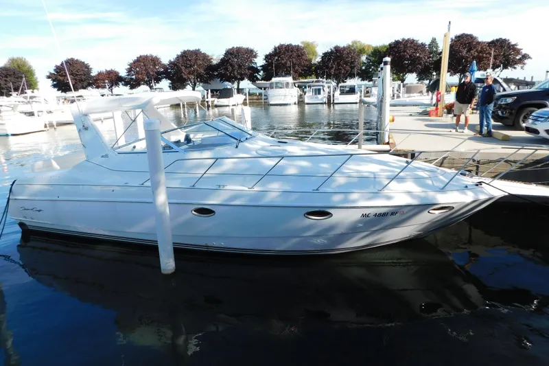 Slide: The Image of 1996 Chris-Craft 340 Crowne boat docked at a marina with clear skies. - 2