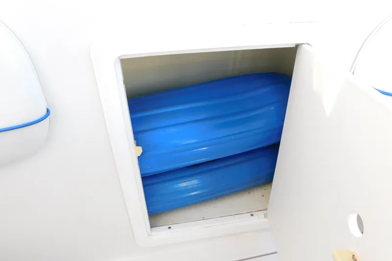 Slide: The Image of Storage compartment on a 1996 Chris-Craft 340 Crowne boat, containing blue items. - 28