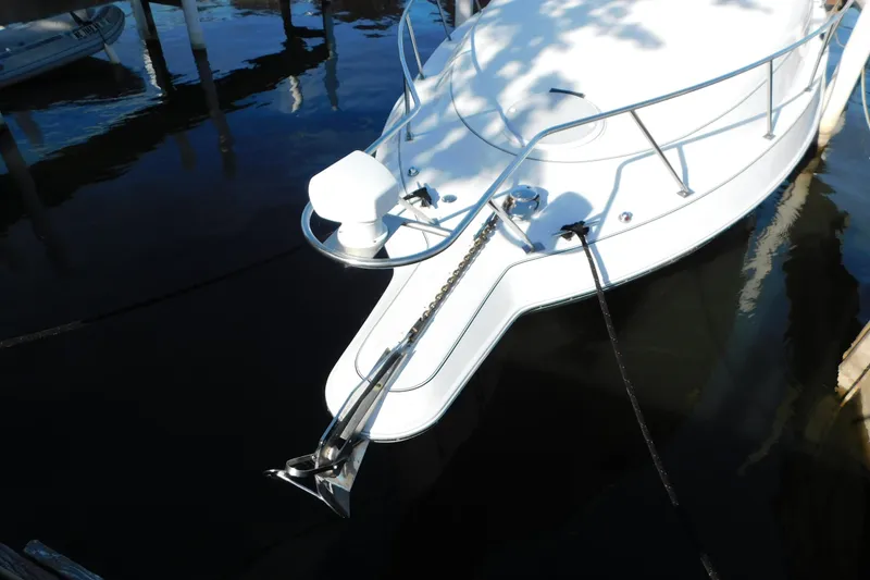 Slide: The Image of 1996 Chris-Craft 340 Crowne boat docked, showing anchor and bow details. - 3