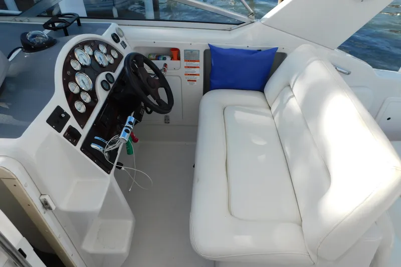 Slide: The Image of 1996 Chris-Craft 340 Crowne boat interior with steering wheel and white seating. - 33
