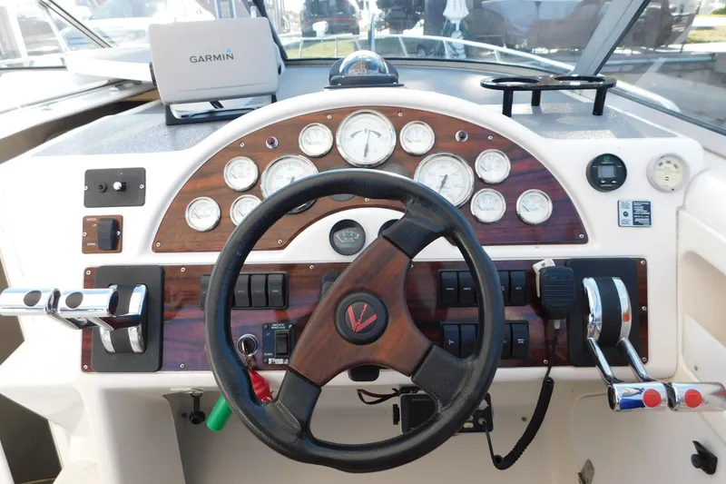 Slide: The Image of 1996 Chris-Craft 340 Crowne boat dashboard with steering wheel and Garmin navigation system. - 34