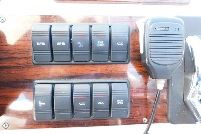 Slide: The Image of Control panel of a 1996 Chris-Craft 340 Crowne boat with switches and microphone. - 35