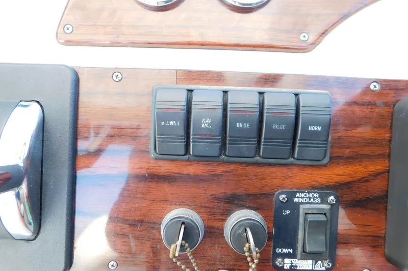 Slide: The Image of 1996 Chris-Craft 340 Crowne dashboard with switches and anchor windlass controls. - 36