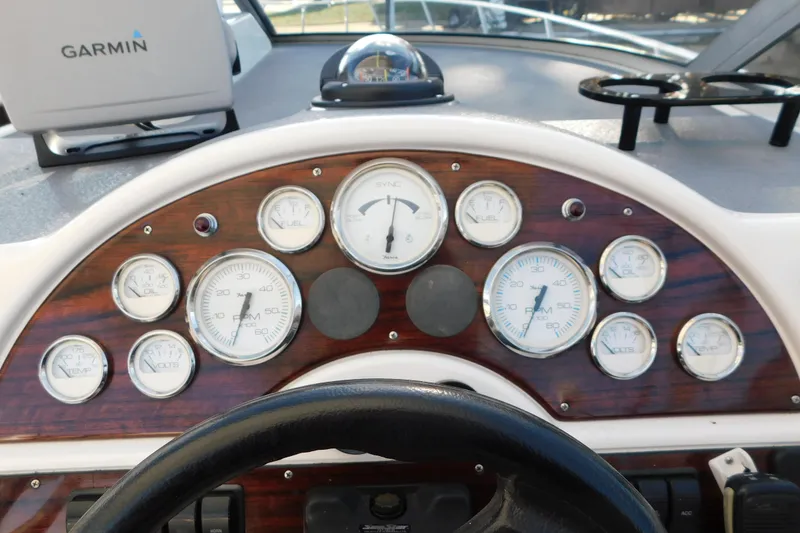 Slide: The Image of Dashboard of a 1996 Chris-Craft 340 Crowne boat with gauges and Garmin device. - 37