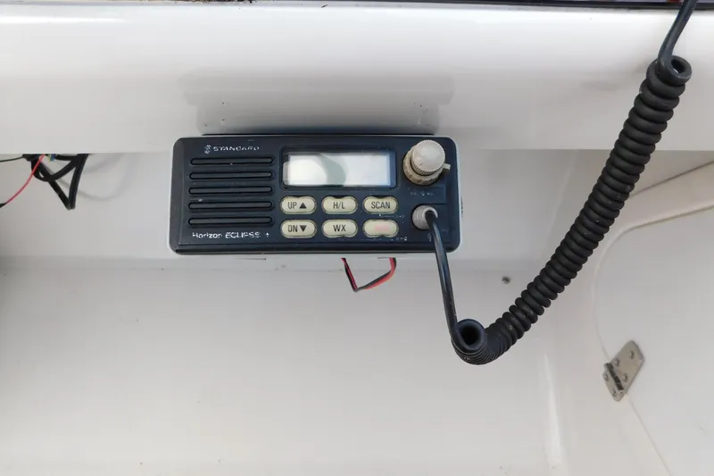 Slide: The Image of VHF radio on 1996 Chris-Craft 340 Crowne boat dashboard, featuring coiled microphone. - 39