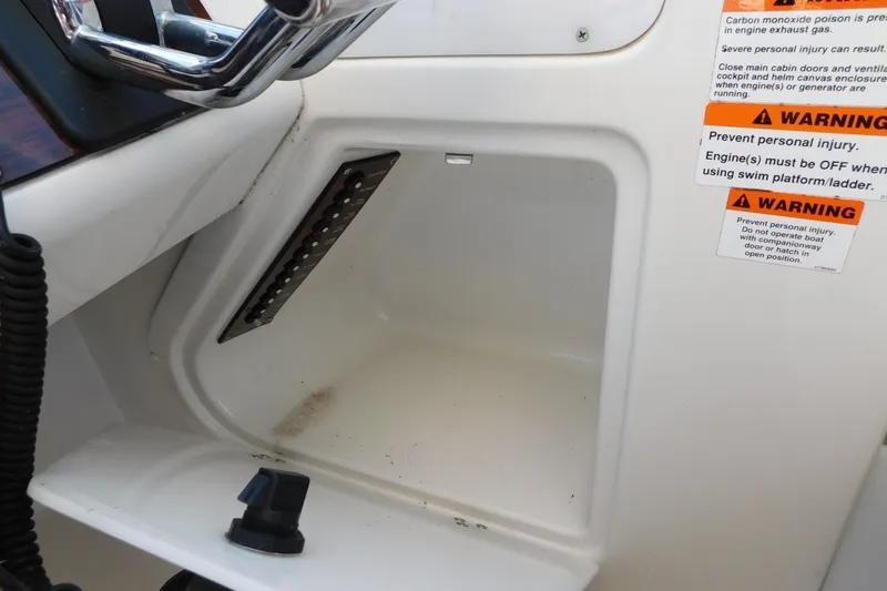 Slide: The Image of 1996 Chris-Craft 340 Crowne cockpit with warning labels and control panel. - 41