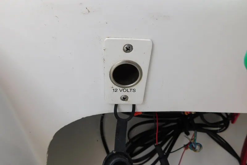 Slide: The Image of 12-volt socket on 1996 Chris-Craft 340 Crowne boat, with visible wiring. - 42