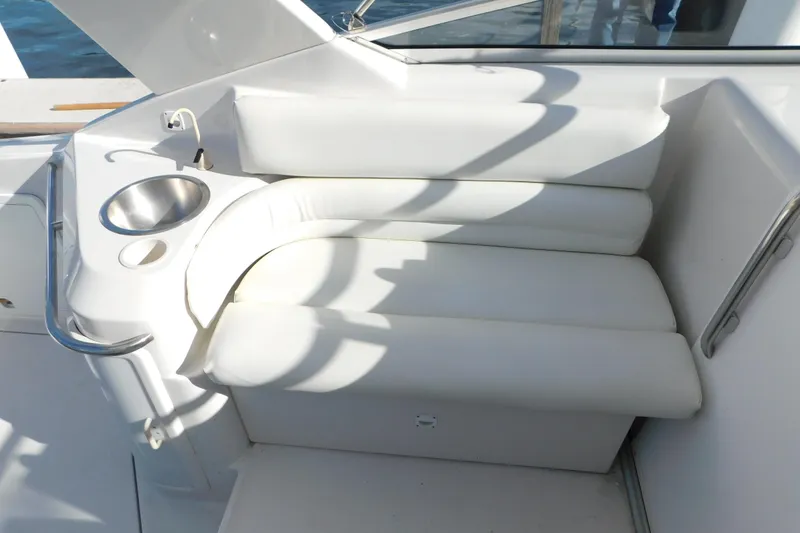 Slide: The Image of 1996 Chris-Craft 340 Crowne boat interior with white seating and stainless steel cup holder. - 44