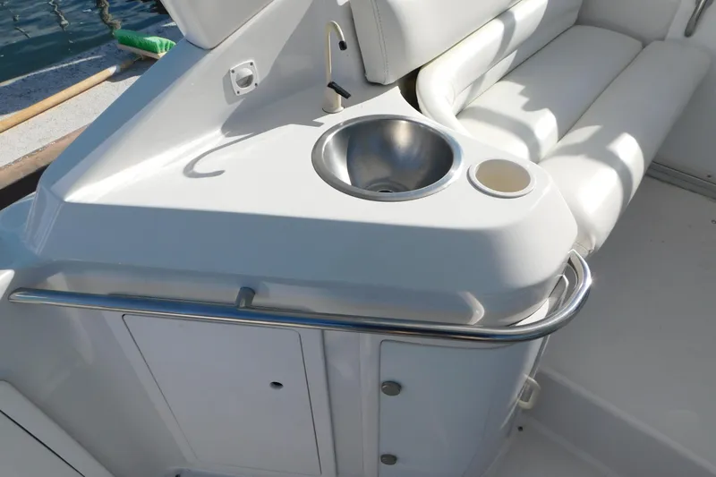 Slide: The Image of 1996 Chris-Craft 340 Crowne boat interior with sink and white seating. - 46