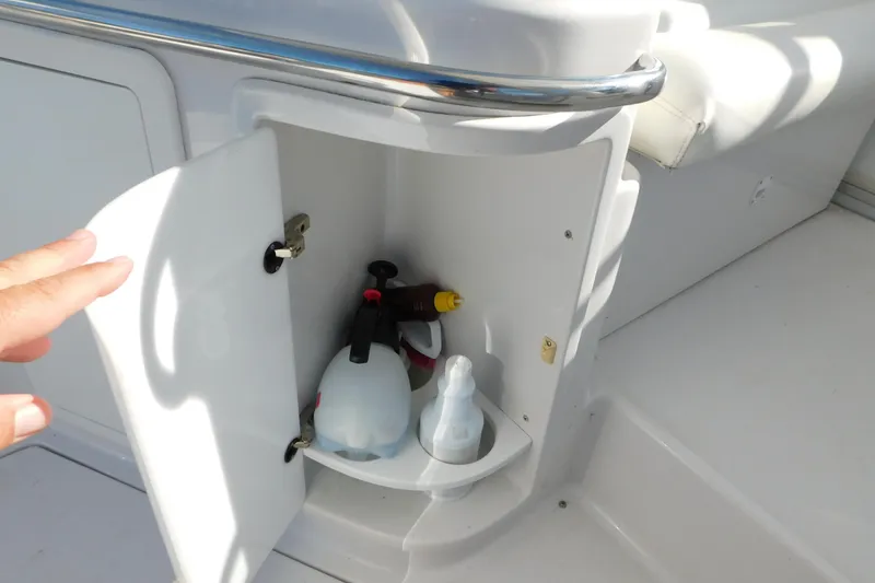 Slide: The Image of Open storage compartment on 1996 Chris-Craft 340 Crowne boat with cleaning supplies. - 48