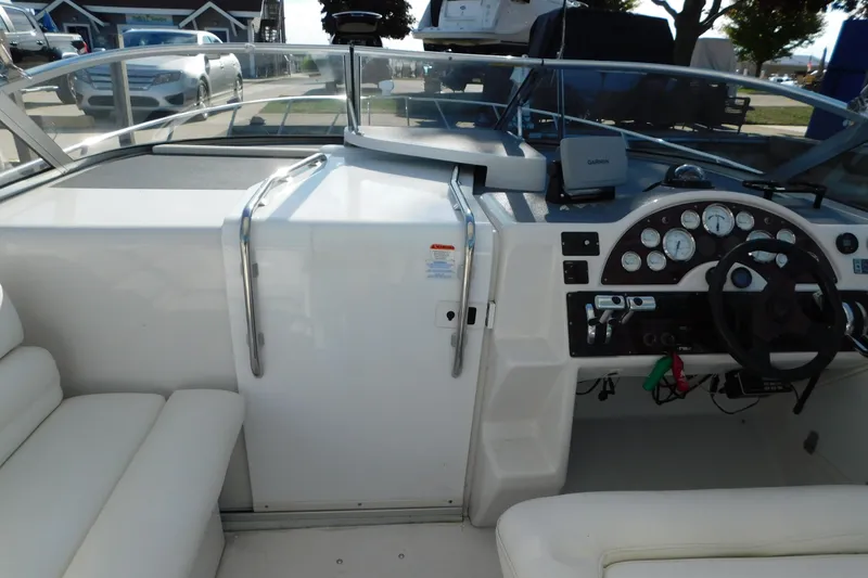 Slide: The Image of 1996 Chris-Craft 340 Crowne boat cockpit with steering wheel and dashboard controls. - 49