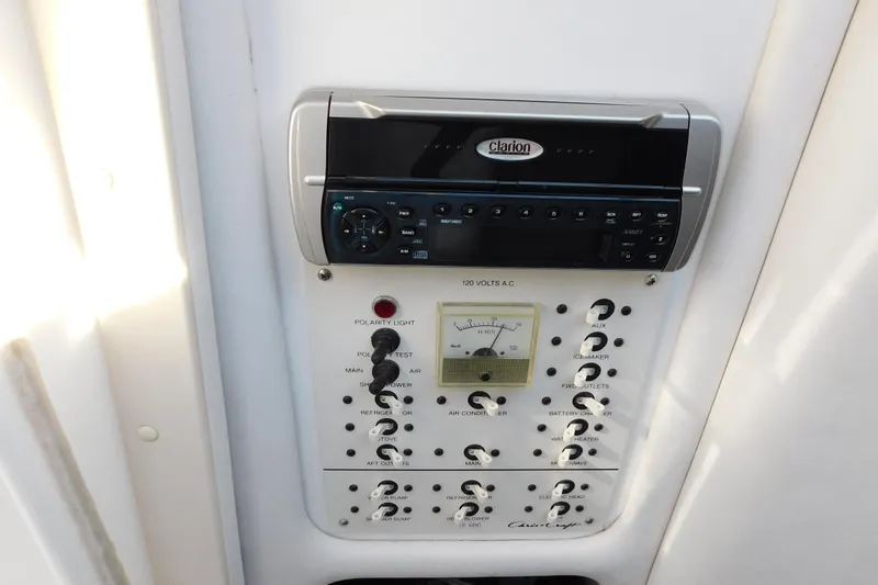 Slide: The Image of 1996 Chris-Craft 340 Crowne control panel with Clarion audio system and voltage meter. - 57