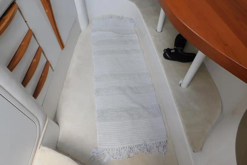 Slide: The Image of Interior of 1996 Chris-Craft 340 Crowne with white rug and wooden table. - 62