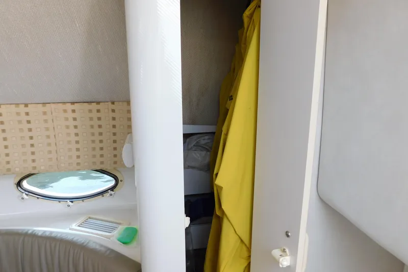 Slide: The Image of Interior of 1996 Chris-Craft 340 Crowne boat with porthole and yellow raincoat. - 66