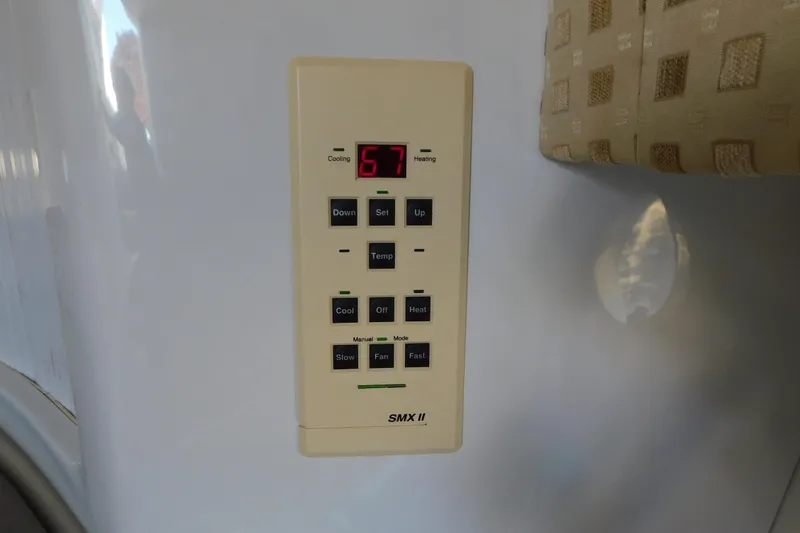 Slide: The Image of Thermostat control panel on 1996 Chris-Craft 340 Crowne boat, displaying temperature settings. - 69