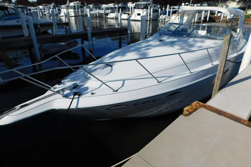 Slide: The Image of 1996 Chris-Craft 340 Crowne boat docked at marina, surrounded by other vessels. - 7
