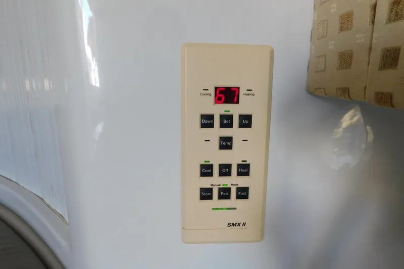 Slide: The Image of Thermostat control panel on 1996 Chris-Craft 340 Crowne boat, displaying temperature settings. - 70