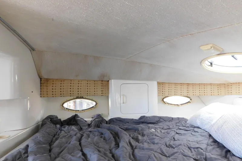 Slide: The Image of Interior cabin of 1996 Chris-Craft 340 Crowne boat with bed and portholes. - 72