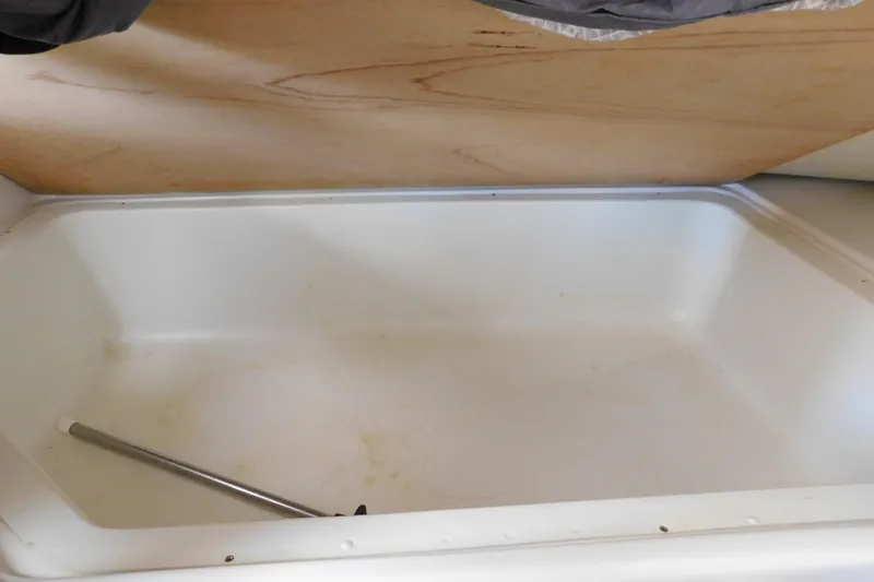 Slide: The Image of Open storage compartment in 1996 Chris-Craft 340 Crowne boat, featuring a white interior. - 73