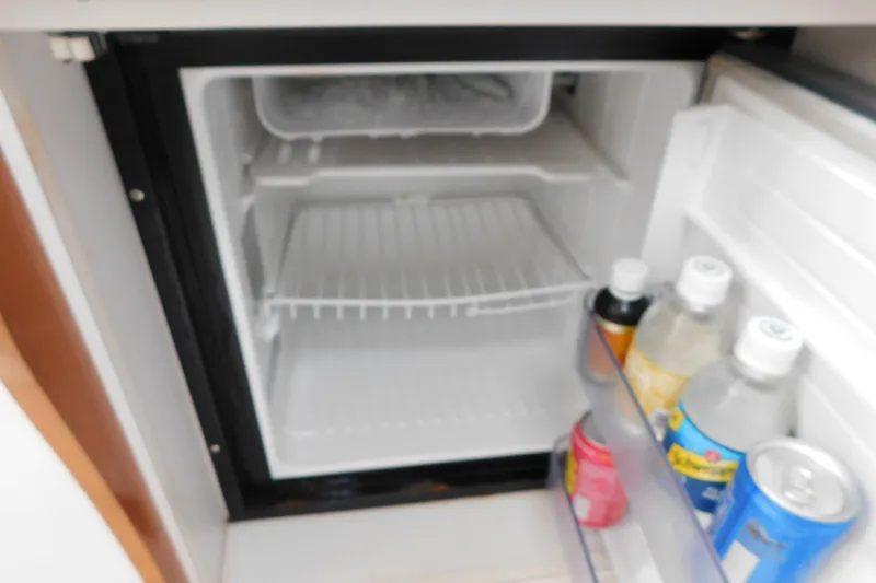 Slide: The Image of Mini fridge inside 1996 Chris-Craft 340 Crowne boat, stocked with beverages. - 82