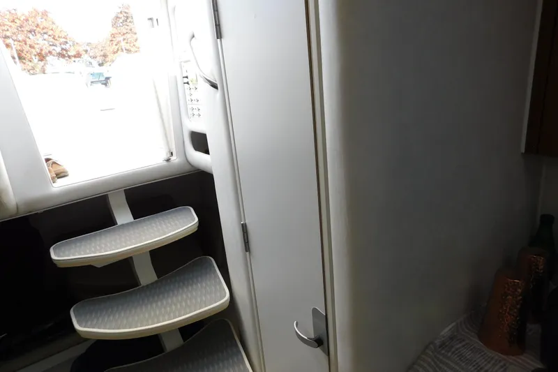 Slide: The Image of 1996 Chris-Craft 340 Crowne interior with steps and door, showcasing sleek design. - 84