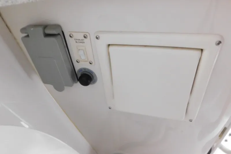 Slide: The Image of 1996 Chris-Craft 340 Crowne boat interior showing exhaust blower switch and panel. - 87