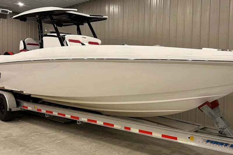The Image of 2023 Sunsation 32 CCX boat on trailer in indoor storage facility. - 1