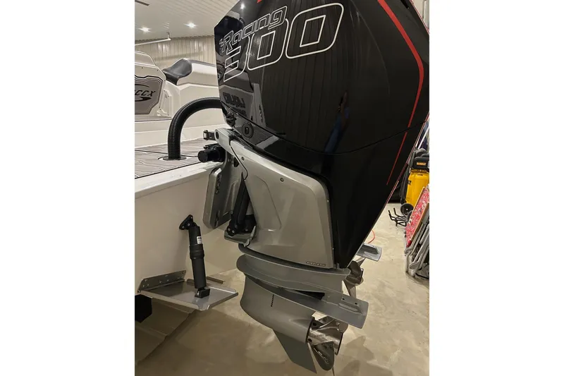 Slide: The Image of 2023 Sunsation 32 CCX boat with powerful outboard engine in a garage setting. - 12