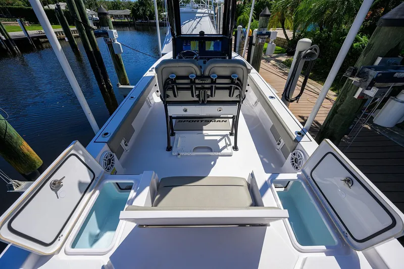Slide: The Image of 2023 Sportsman Masters 247OE Bay Boat interior with open storage compartments and seating. - 13