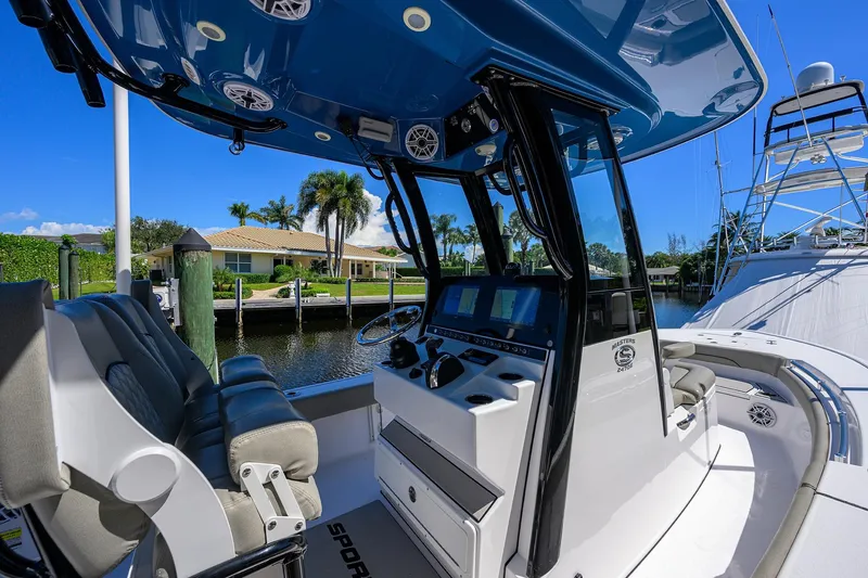 Slide: The Image of 2023 Sportsman Masters 247OE Bay Boat interior with modern console and seating. - 14