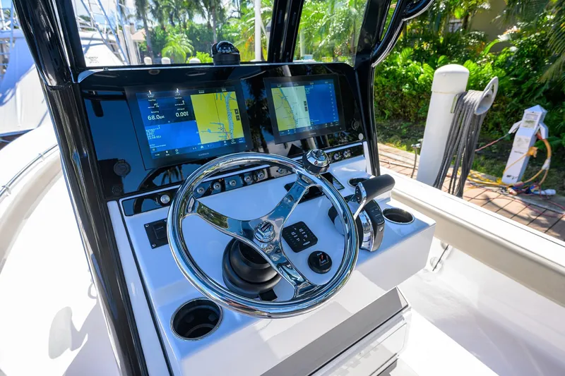Slide: The Image of 2023 Sportsman Masters 247OE Bay Boat dashboard with advanced navigation displays. - 18