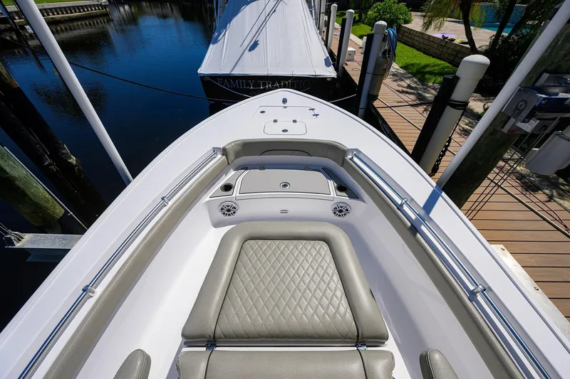 Slide: The Image of 2023 Sportsman Masters 247OE Bay Boat, docked, featuring sleek seating and modern design. - 23