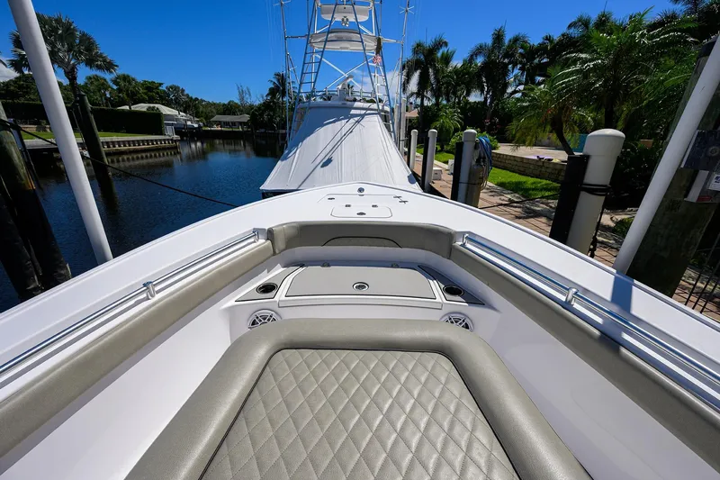 Slide: The Image of 2023 Sportsman Masters 247OE Bay Boat docked, showcasing sleek design and spacious deck. - 24