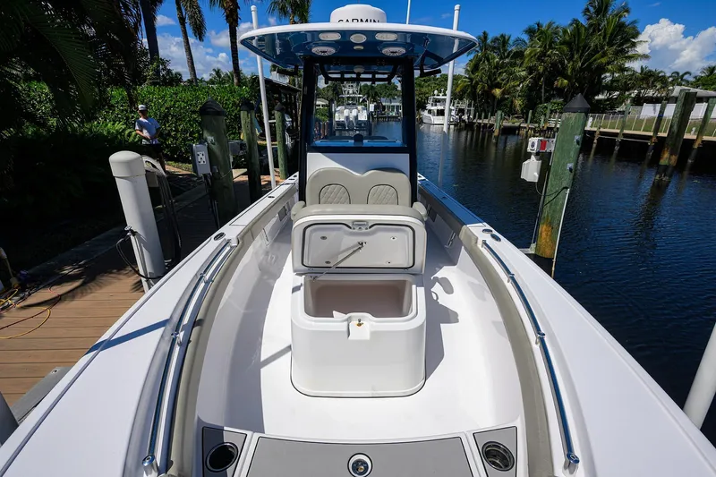 Slide: The Image of 2023 Sportsman Masters 247OE Bay Boat docked, featuring open storage compartment. - 25