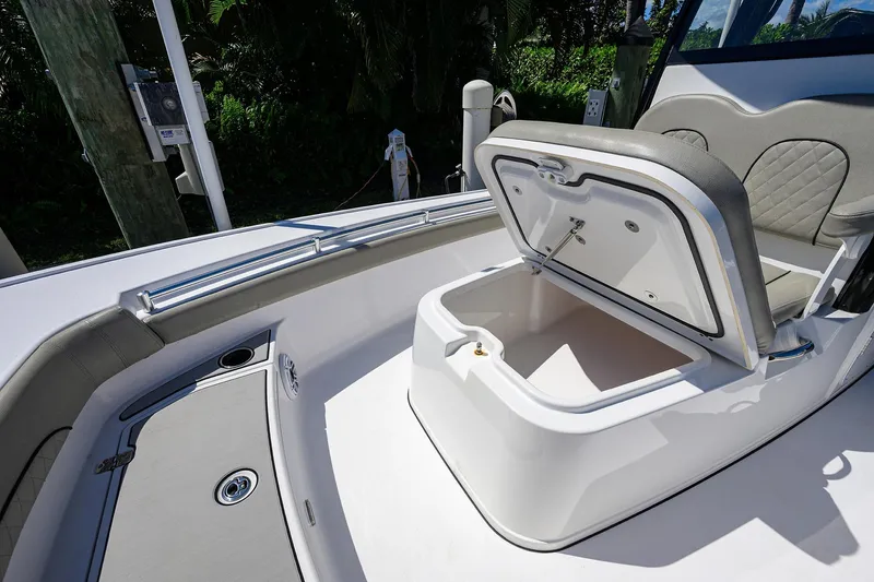 Slide: The Image of 2023 Sportsman Masters 247OE Bay Boat with open storage compartment and cushioned seating. - 26