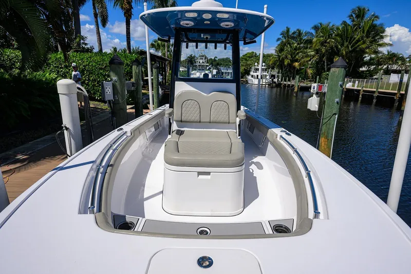 Slide: The Image of 2023 Sportsman Masters 247OE Bay Boat docked, showcasing seating and sleek design. - 27
