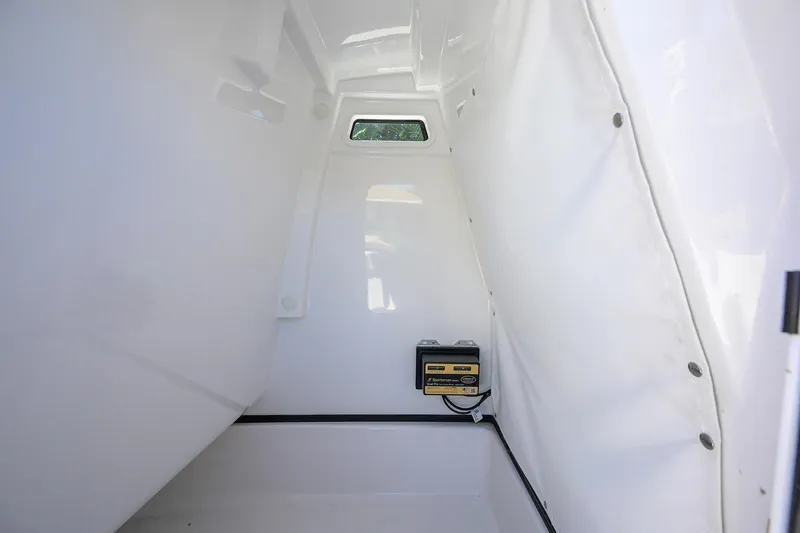 Slide: The Image of Interior of 2023 Sportsman Masters 247OE Bay Boat, featuring storage compartment and equipment. - 29