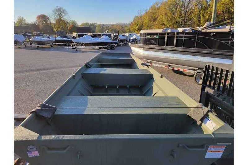 Slide: The Image of 2024 Polar Kraft 1436 Jon Boat with trailer, parked outdoors in a boatyard. - 3