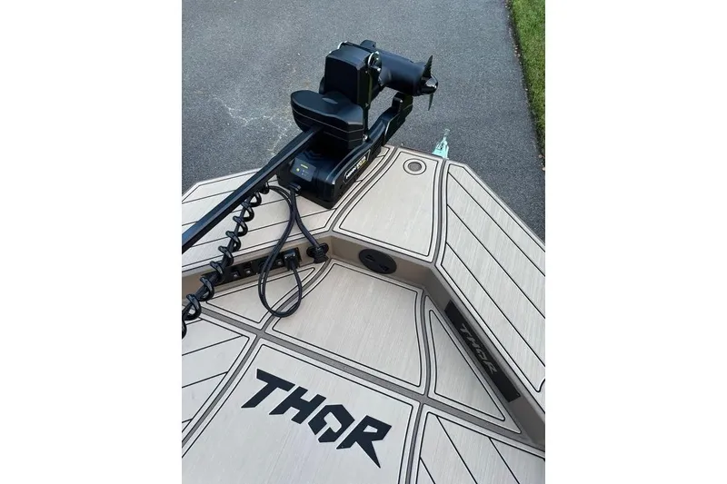 Slide: The Image of 2025 Thor Lake Hammer boat deck with motor, featuring sleek design and branding. - 11